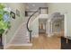 Grand foyer with a sweeping staircase and gleaming hardwood floors, creating an elegant first impression at 715 Newport Holw, Alpharetta, GA 30005