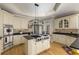 Elegant kitchen with stainless steel appliances, granite countertops, and a stylish central island with range at 715 Newport Holw, Alpharetta, GA 30005