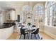 Cozy kitchen nook with table and chairs, surrounded by large arched windows offering abundant natural light at 715 Newport Holw, Alpharetta, GA 30005