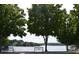 Scenic lake view featuring mature trees and benches for residents to enjoy the outdoors at 715 Newport Holw, Alpharetta, GA 30005