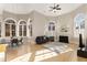 Open concept living area with fireplace, large arched windows, and hardwood floors with lots of sunlight at 715 Newport Holw, Alpharetta, GA 30005