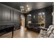 Elegant living room featuring custom dark trim work and hardwood flooring next to a large bright window at 715 Newport Holw, Alpharetta, GA 30005