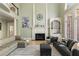 Open-concept living room with a fireplace, built-in shelves, large windows, and comfortable seating at 715 Newport Holw, Alpharetta, GA 30005