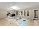 Open concept living room featuring tile floors and a large window showcasing the backyard at 715 Newport Holw, Alpharetta, GA 30005