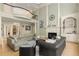 Spacious living room with a fireplace, tall columns, and a second-story balcony overlooking the space at 715 Newport Holw, Alpharetta, GA 30005