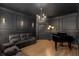 Elegant living room featuring custom dark trim work, hardwood flooring, and a black baby grand piano at 715 Newport Holw, Alpharetta, GA 30005