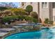 The pool has a waterfall feature cascading into the turquoise water at 715 Newport Holw, Alpharetta, GA 30005