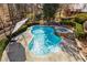 Refreshing kidney-shaped pool and hot tub, surrounded by lush greenery, offering a private outdoor retreat at 715 Newport Holw, Alpharetta, GA 30005