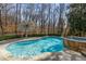A tranquil pool and hot tub are nestled among trees and manicured hedges at 715 Newport Holw, Alpharetta, GA 30005