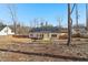 A wide view of the expansive backyard, with a covered patio and wood fence at 814 Harmony Rd, Temple, GA 30179