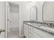 Bathroom featuring a double vanity with granite countertops and a view into the shower/tub area at 814 Harmony Rd, Temple, GA 30179