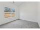 Neutral bedroom with carpet flooring and a large window with backyard views at 814 Harmony Rd, Temple, GA 30179