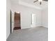 Bright bedroom featuring neutral walls, a ceiling fan, and access to both the stairs and bathroom at 814 Harmony Rd, Temple, GA 30179