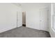 Neutral bedroom with carpet flooring, closet, and a large window at 814 Harmony Rd, Temple, GA 30179