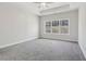 Spacious primary bedroom featuring a tray ceiling, ceiling fan and large window at 814 Harmony Rd, Temple, GA 30179