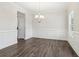 Dining room with wainscoting, crown molding, chandelier, and wood-look floors at 814 Harmony Rd, Temple, GA 30179