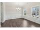 Dining room featuring decorative trim, wood-look floors, and natural light from two windows at 814 Harmony Rd, Temple, GA 30179