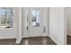 Bright entryway with white trim, wood-look flooring, and a glass-paneled front door at 814 Harmony Rd, Temple, GA 30179