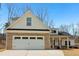 Charming home with a brick facade on the garage and white siding under a blue sky at 814 Harmony Rd, Temple, GA 30179