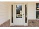 Close-up of the white front door framed by sidelights, showcasing the home's welcoming entrance at 814 Harmony Rd, Temple, GA 30179