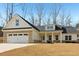 Beautiful exterior view of the brick and siding home with well manicured lawn and a two-car garage at 814 Harmony Rd, Temple, GA 30179