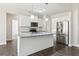 Bright kitchen features granite countertops, stainless appliances and large island at 814 Harmony Rd, Temple, GA 30179
