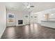 Open living room with fireplace flows into the kitchen with breakfast bar and modern finishes at 814 Harmony Rd, Temple, GA 30179