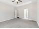 An expansive primary bedroom with tray ceilings, ceiling fan, and neutral carpet at 814 Harmony Rd, Temple, GA 30179