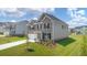 Charming two-story home with manicured lawn and attached two-car garage at 1059 Blue Juniper Cir, Loganville, GA 30052