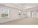 Large main bedroom featuring a tray ceiling, neutral colors, and natural light from multiple windows at 1059 Blue Juniper Cir, Loganville, GA 30052