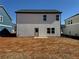 The backyard of this new home construction has a gray exterior and small patio at 2108 Boxwood Circle Se, Conyers, GA 30094