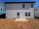 Backyard of new home construction with gray exterior and small patio at 2108 Boxwood Circle Se, Conyers, GA 30094