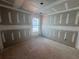 An unfinished bedroom featuring a window with drywall ready for customization at 2108 Boxwood Circle Se, Conyers, GA 30094