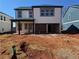 New two-story home featuring light siding, black trim, a covered patio, and an unfinished yard at 2108 Boxwood Circle Se, Conyers, GA 30094