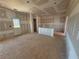 Open concept living space with unfinished walls and rear exit to private backyard at 2108 Boxwood Circle Se, Conyers, GA 30094