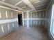 The interior of the new home shows an empty room with the unfinished construction of sheetrock walls and ceiling at 2108 Boxwood Circle Se, Conyers, GA 30094