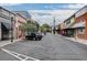 A view of downtown with a line of store fronts and vehicles along the side of the road at 2108 Boxwood Circle Se, Conyers, GA 30094