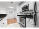 Updated kitchen boasts stainless steel appliances, granite counters, and white cabinets at 3103 Santa Fe Pkwy, Atlanta, GA 30350