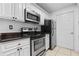 Kitchen with stainless steel appliances, white cabinetry, and dark countertops at 3103 Santa Fe Pkwy, Atlanta, GA 30350