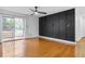 This living room has hardwood flooring, and black accent wall and natural lighting at 3103 Santa Fe Pkwy, Atlanta, GA 30350