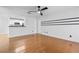 Open-concept living room featuring hardwood floors, a ceiling fan, and a view of the kitchen at 3103 Santa Fe Pkwy, Atlanta, GA 30350