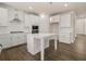 Bright kitchen featuring white cabinets, a stainless steel range hood, and an island at 4075 Near Star Ln, Cumming, GA 30028