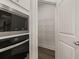 Pantry with wire shelving and view of microwave and oven at 4075 Near Star Ln, Cumming, GA 30028