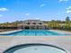 An in-ground neighborhood pool has a pool house, black fencing, and a blue sky background at 4075 Near Star Ln, Cumming, GA 30028