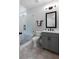 Modern bathroom showcasing a glass-enclosed shower, gray vanity, and neutral hexagon tile flooring at 805 Dempsey Ct, Marietta, GA 30064