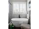 Bathroom featuring a free-standing tub with a window with plantation shutters at 805 Dempsey Ct, Marietta, GA 30064