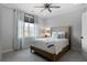 Cozy bedroom featuring a ceiling fan, large window, and a comfortable bed with stylish blue and white patterned pillows at 805 Dempsey Ct, Marietta, GA 30064