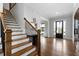 Bright foyer with hardwood floors, staircase with black metal railings, and a dark wood front door with sidelights at 805 Dempsey Ct, Marietta, GA 30064