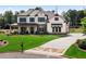 Charming two-story home with a manicured lawn, stone accents, and covered front porch at 805 Dempsey Ct, Marietta, GA 30064