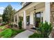 Inviting front porch with classic columns, lush landscaping, and a cozy seating area at 805 Dempsey Ct, Marietta, GA 30064